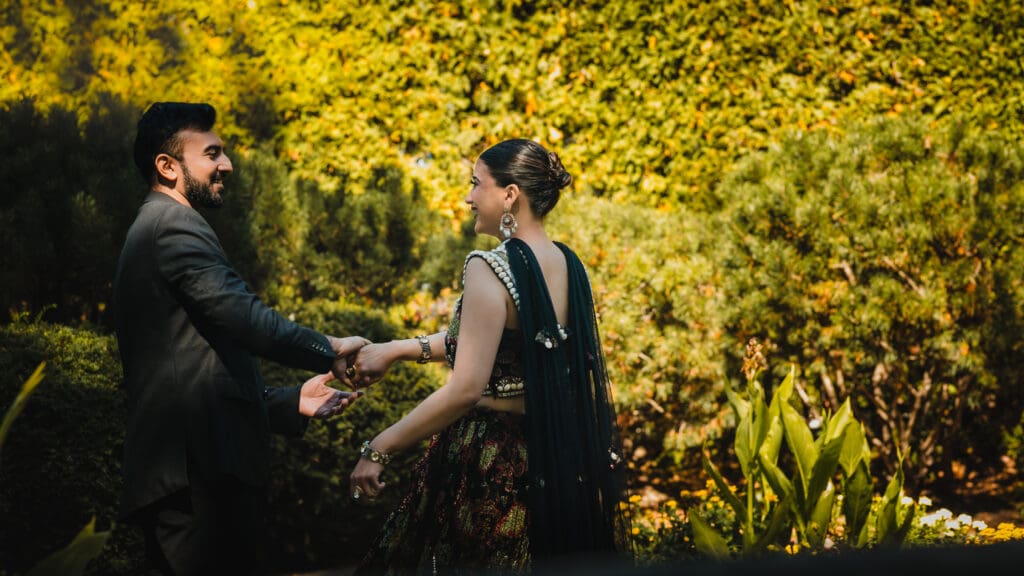 South Asian bride laughing at groom while holding hands at Parkwood Estate, Oshawa — candid cinematic wedding portrait