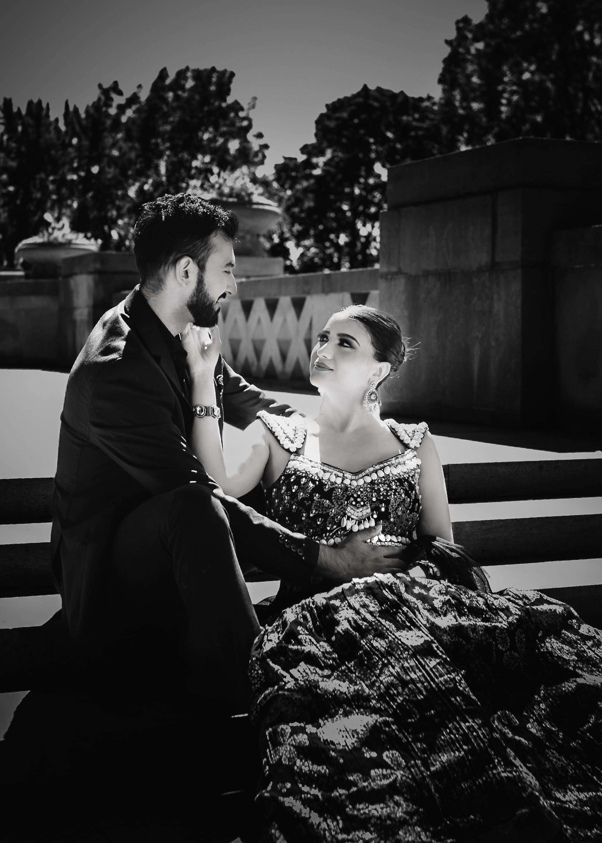 Black and white wedding couple portrait on stone stairs at Parkwood Estate in Oshawa, Ontario, groom leaning close as bride looks up at him, romantic cinematic wedding photography near Toronto and GTA.